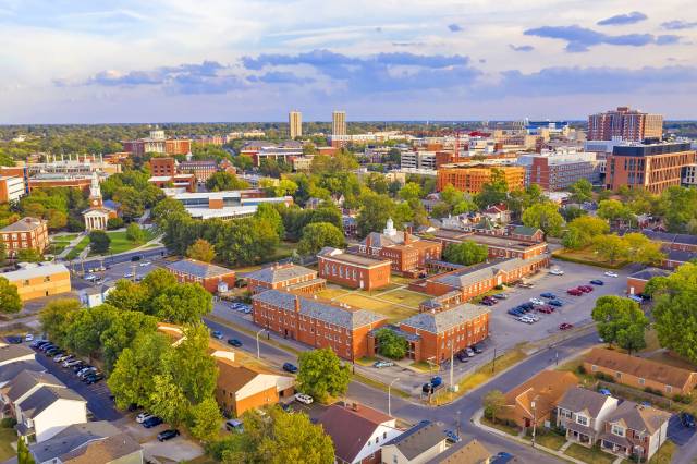 Aerial view of Lexington, Kentucky, showcasing a vibrant cityscape with trees, historic buildings, and urban architecture.