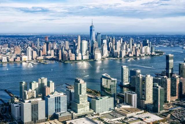 Aerial view of New York City skyline with skyscrapers and waterfront, highlighting urban architecture and cityscape beauty.